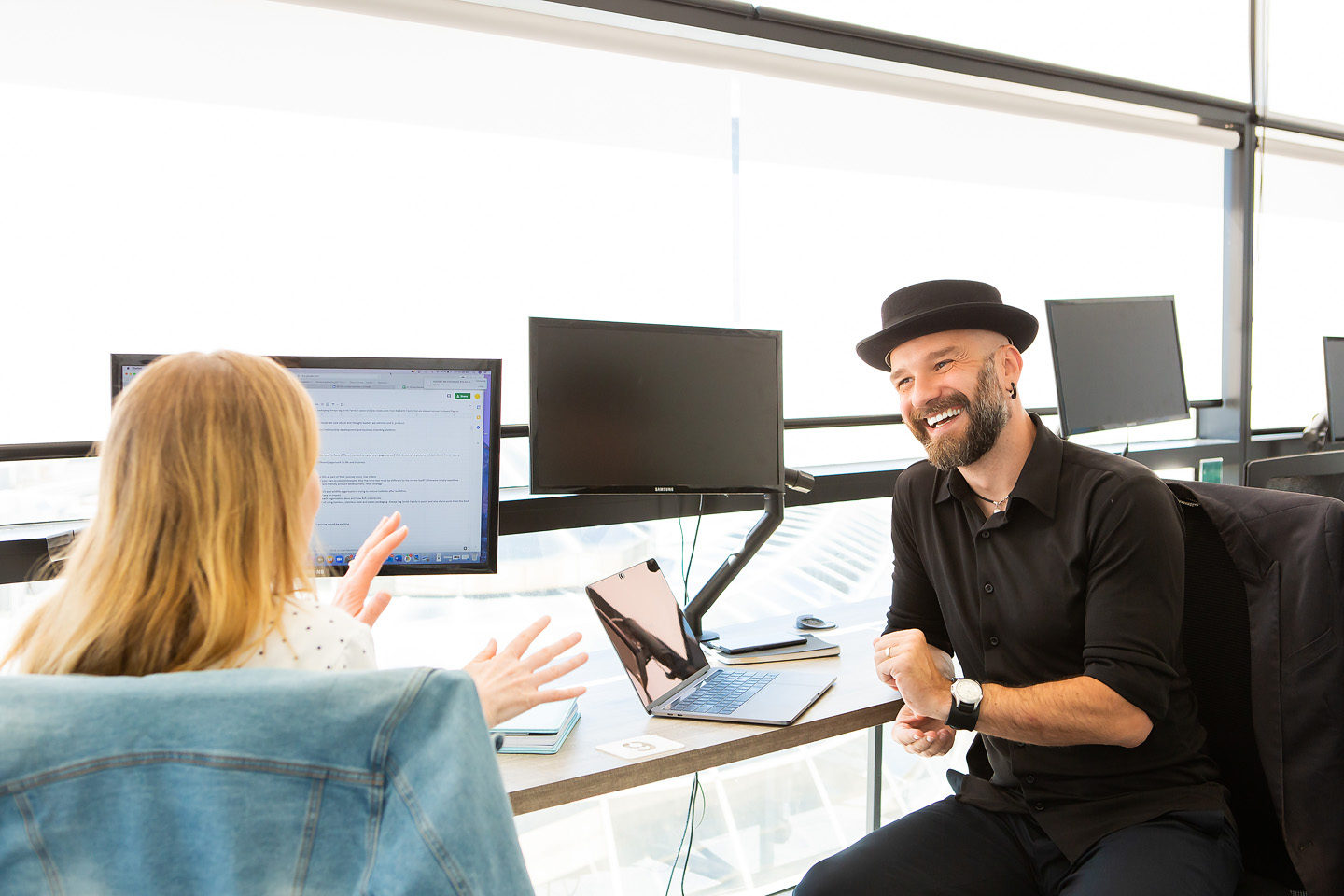 Arek collaborating with a team member at a desk